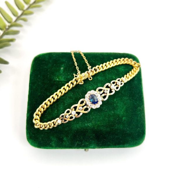Edwardian Antique Sapphire and Diamond Cluster Fancy Heart Link Gold Curb Bracelet, 18ct yellow gold curb link bracelet with central oval sapphire and diamond cluster flanked by diamond-set heart-shaped links, Circa 1900