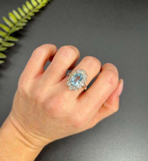 Vintage 2ct Aquamarine and Diamond Cluster Engagement Ring, oval aquamarine surrounded by 2cts sparkling diamonds set in white gold to 18ct yellow gold band with elegant pinched shoulders. Circa 1960s