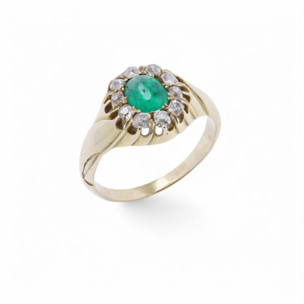 Emerald and diamond cluster ring in gold.