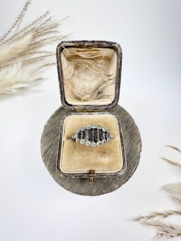 Art Deco Old Cut Diamond and Onyx Ring in Platinum, alternating bands of old-cut diamonds and black onyx with a decorative reeded band. Circa 1920s