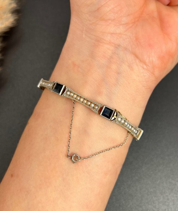 Edwardian Antique Sapphire and Seed Pearl Link Bracelet, long rectangular links with delicate row of natural seed pearls interspersed with square-cut sapphires in platinum and 18ct yellow gold.. Circa 1910