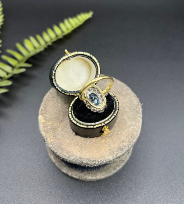 Vintage 2ct Aquamarine and Diamond Cluster Engagement Ring, oval aquamarine surrounded by 2cts sparkling diamonds set in white gold to 18ct yellow gold band with elegant pinched shoulders. Circa 1960s