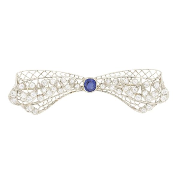 Vintage Antique Art Deco 3.4ct Old Cut Diamond and Sapphire Bow Brooch in Platinum, 1ct old cushion cut sapphire in diamond encrusted platinum decorative pierced framework with original antique velvet-lined fitted box. Circa 1920s