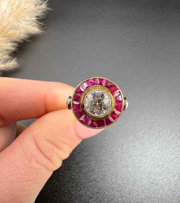 Vintage Antique Art Deco Diamond and Ruby Halo Target Cluster Engagement Ring, 0.65ct diamond framed by border of calibre red rubies in platinum and 18ct yellow gold. Circa 1920s