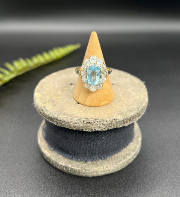 Vintage 2ct Aquamarine and Diamond Cluster Engagement Ring, oval aquamarine surrounded by 2cts sparkling diamonds set in white gold to 18ct yellow gold band with elegant pinched shoulders. Circa 1960s