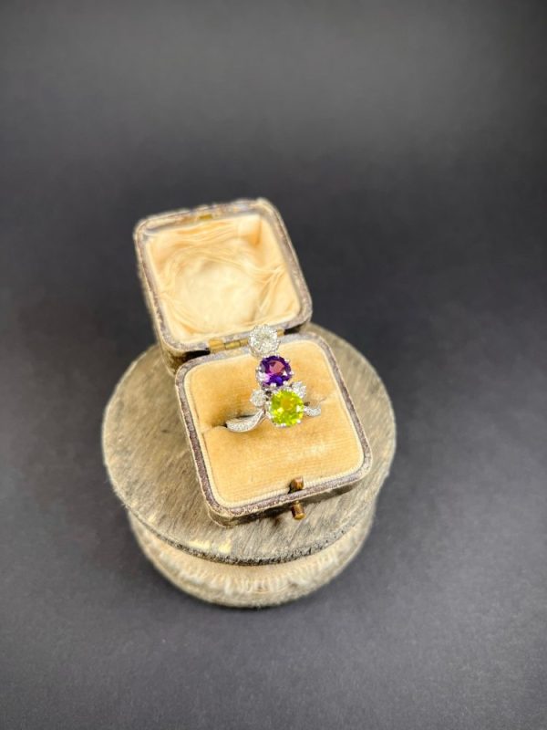Edwardian Antique French Suffragette Amethyst Peridot Diamond Three Stone Ring, graduating trilogy of peridot amethyst and diamond arranged vertically up the finger when worn in 18ct white gold on diamond-set band with French eagles head stamp