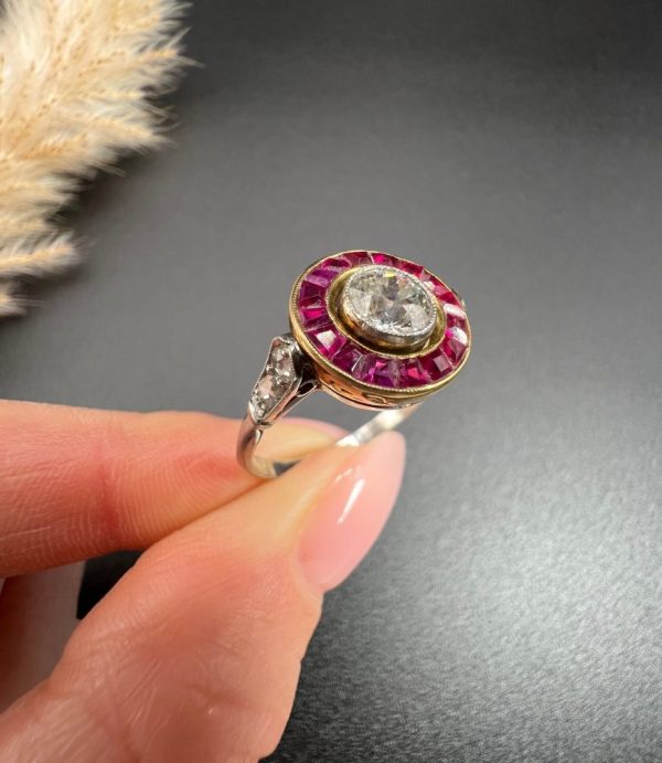 Vintage Antique Art Deco Diamond and Ruby Halo Target Cluster Engagement Ring, 0.65ct diamond framed by border of calibre red rubies in platinum and 18ct yellow gold. Circa 1920s