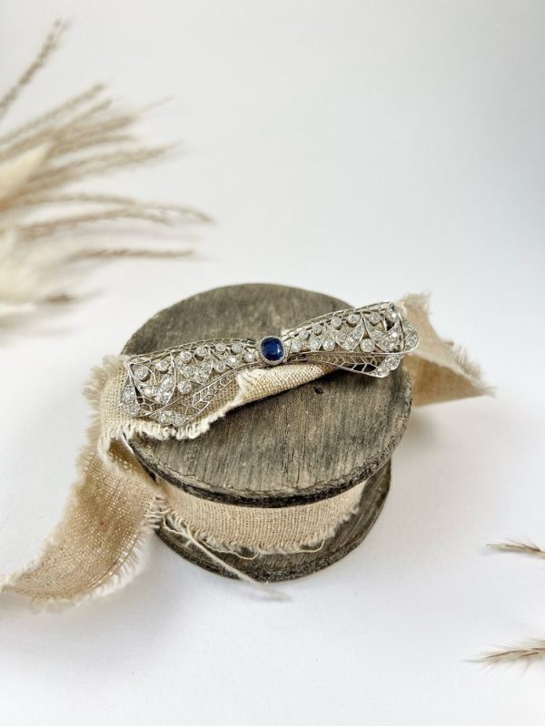 Vintage Antique Art Deco 3.4ct Old Cut Diamond and Sapphire Bow Brooch in Platinum, 1ct old cushion cut sapphire in diamond encrusted platinum decorative pierced framework with original antique velvet-lined fitted box. Circa 1920s