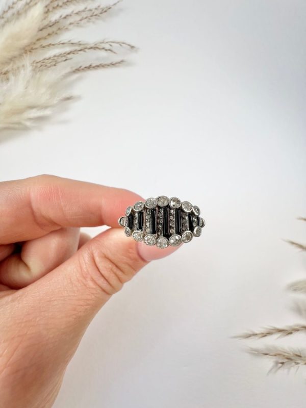 Art Deco Old Cut Diamond and Onyx Ring in Platinum, alternating bands of old-cut diamonds and black onyx with a decorative reeded band. Circa 1920s