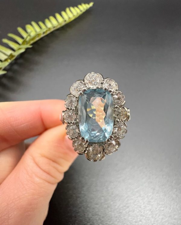 Vintage 2ct Aquamarine and Diamond Cluster Engagement Ring, oval aquamarine surrounded by 2cts sparkling diamonds set in white gold to 18ct yellow gold band with elegant pinched shoulders. Circa 1960s