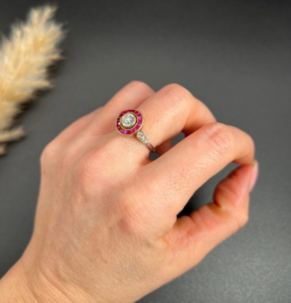 Vintage Antique Art Deco Diamond and Ruby Halo Target Cluster Engagement Ring, 0.65ct diamond framed by border of calibre red rubies in platinum and 18ct yellow gold. Circa 1920s