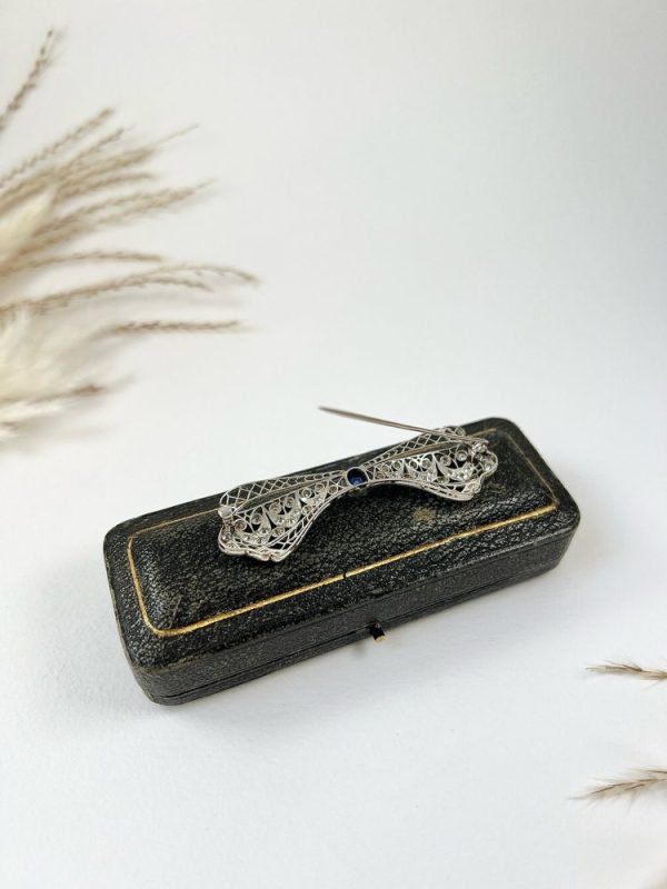 Vintage Antique Art Deco 3.4ct Old Cut Diamond and Sapphire Bow Brooch in Platinum, 1ct old cushion cut sapphire in diamond encrusted platinum decorative pierced framework with original antique velvet-lined fitted box. Circa 1920s