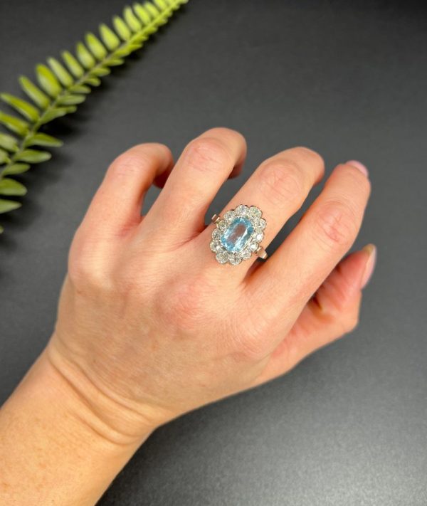 Vintage 2ct Aquamarine and Diamond Cluster Engagement Ring, oval aquamarine surrounded by 2cts sparkling diamonds set in white gold to 18ct yellow gold band with elegant pinched shoulders. Circa 1960s