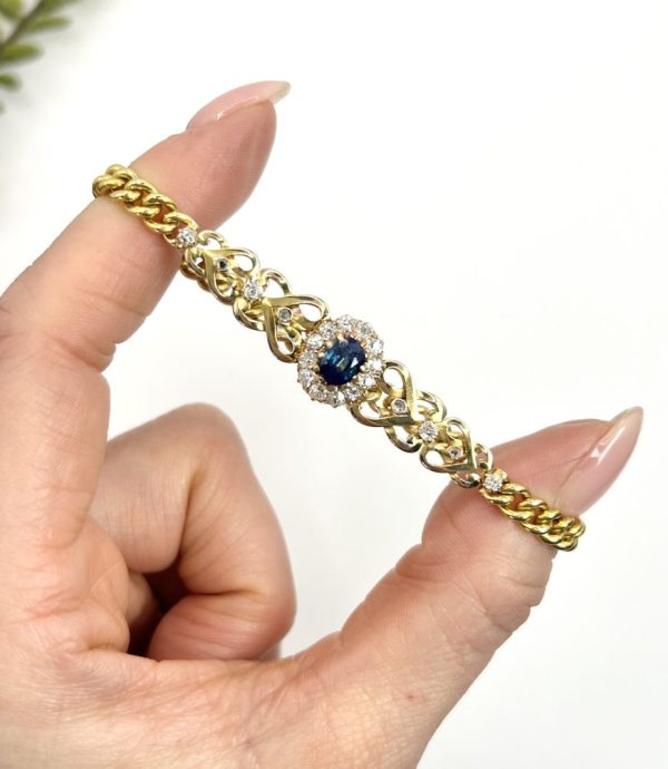 Edwardian Antique Sapphire and Diamond Cluster Fancy Heart Link Gold Curb Bracelet, 18ct yellow gold curb link bracelet with central oval sapphire and diamond cluster flanked by diamond-set heart-shaped links, Circa 1900