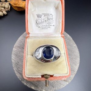 Art Deco French Sapphire and Diamond Five Stone Bombe Ring, oval blue sapphire sits proud flanked by two diamonds running down each shoulder in 18ct white gold. Circa 1920s