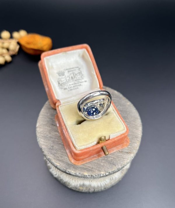 Art Deco French Sapphire and Diamond Five Stone Bombe Ring, oval blue sapphire sits proud flanked by two diamonds running down each shoulder in 18ct white gold. Circa 1920s