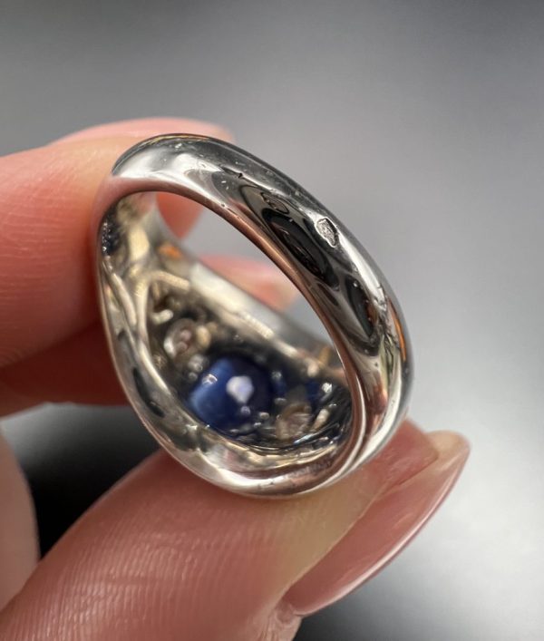 Art Deco French Sapphire and Diamond Five Stone Bombe Ring, oval blue sapphire sits proud flanked by two diamonds running down each shoulder in 18ct white gold. Circa 1920s