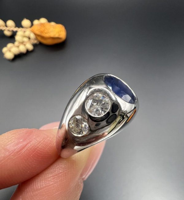 Art Deco French Sapphire and Diamond Five Stone Bombe Ring, oval blue sapphire sits proud flanked by two diamonds running down each shoulder in 18ct white gold. Circa 1920s
