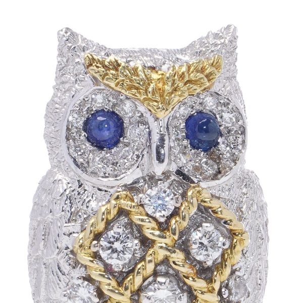 Diamond owl brooch with sapphire eyes in white and yellow gold.