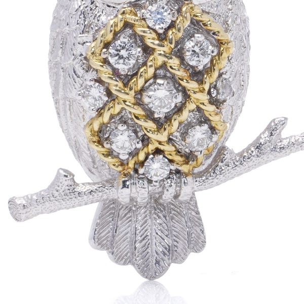 Diamond owl brooch with sapphire eyes in white and yellow gold.