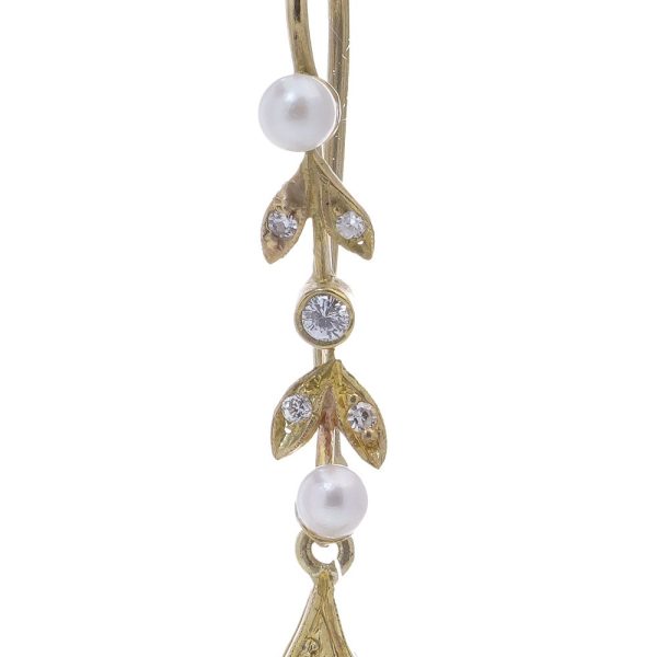 Diamond and pearl drop earrings in gold.
