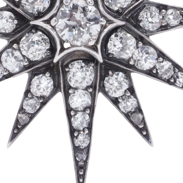 Victorian diamond sunburst star brooch in gold and silver.