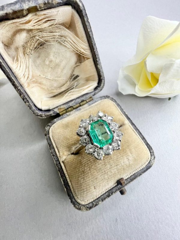 Pre owned emerald and diamond cluster ring
