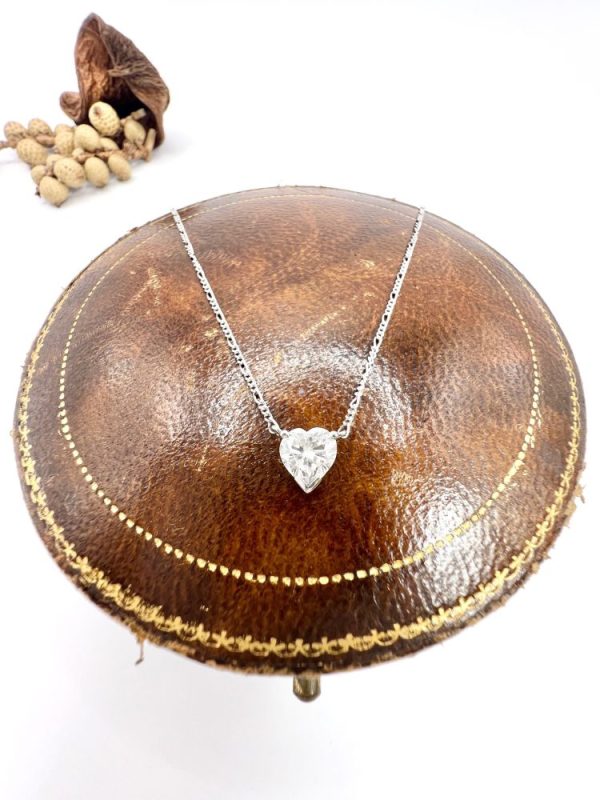 Diamond heart pendant necklace on platinum chain.