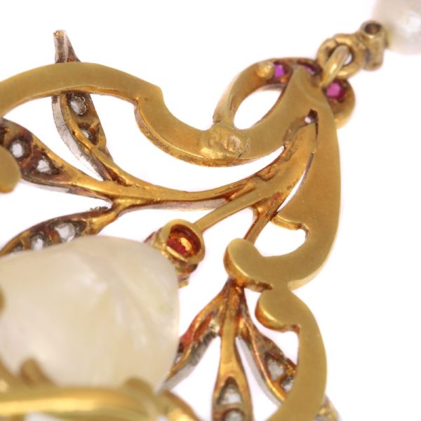 Art Nouveau pearl, diamond and ruby pendant in gold.