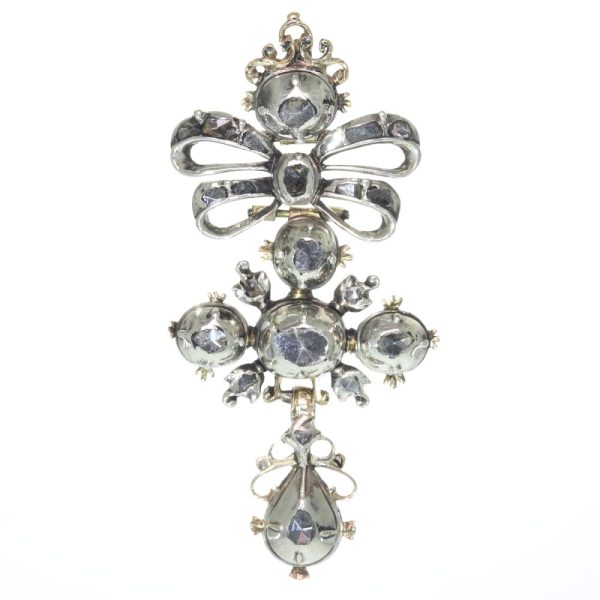 Baroque diamond cross pendant in silver and gold.