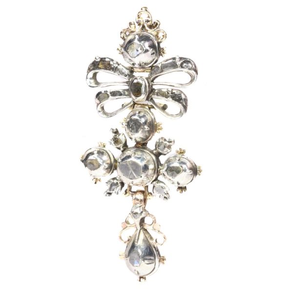 Baroque diamond cross pendant in silver and gold.