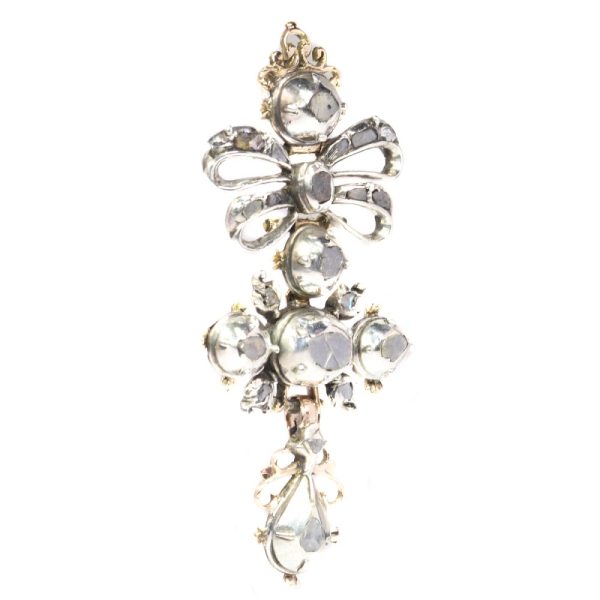Baroque diamond cross pendant in silver and gold.