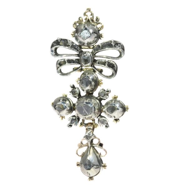 Baroque diamond cross pendant in silver and gold.