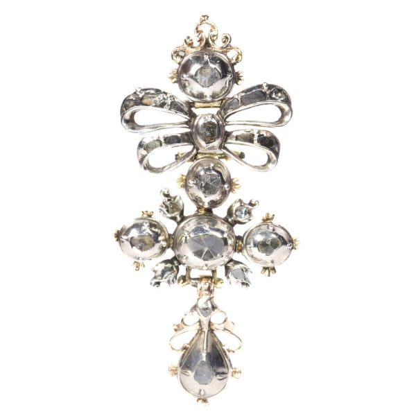 Baroque diamond cross pendant in silver and gold.
