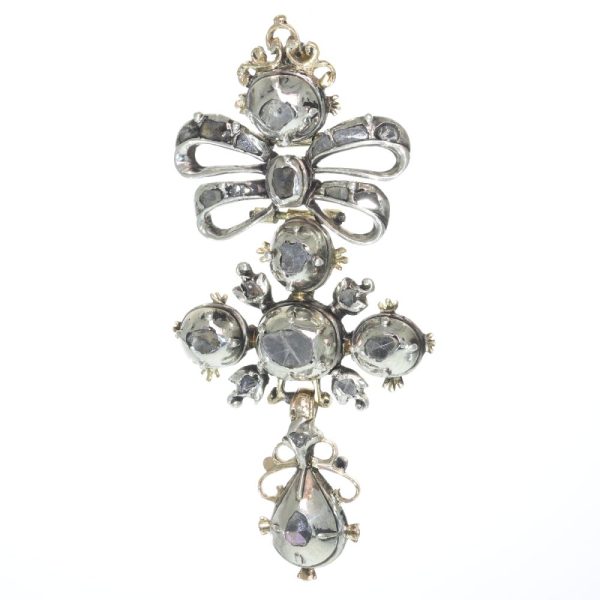 Baroque diamond cross pendant in silver and gold.