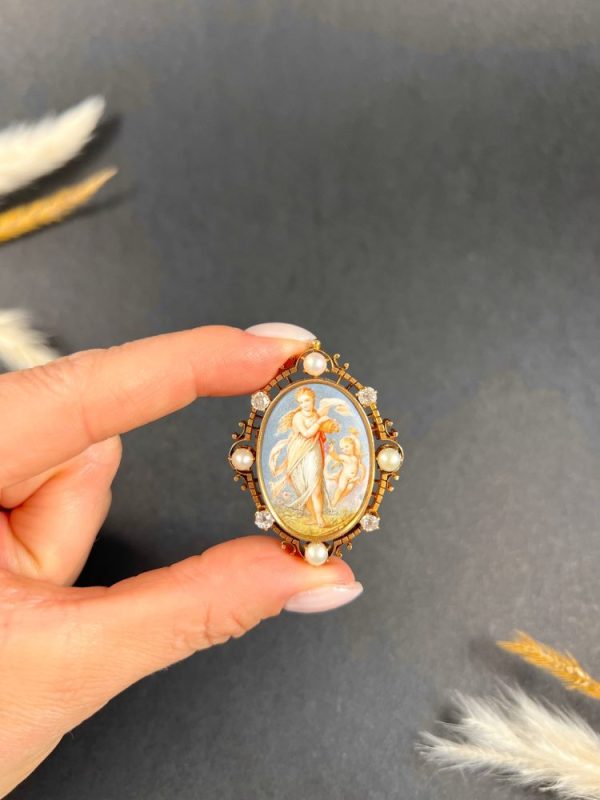 Antique enamel, pearl and diamond portrait brooch in gold.
