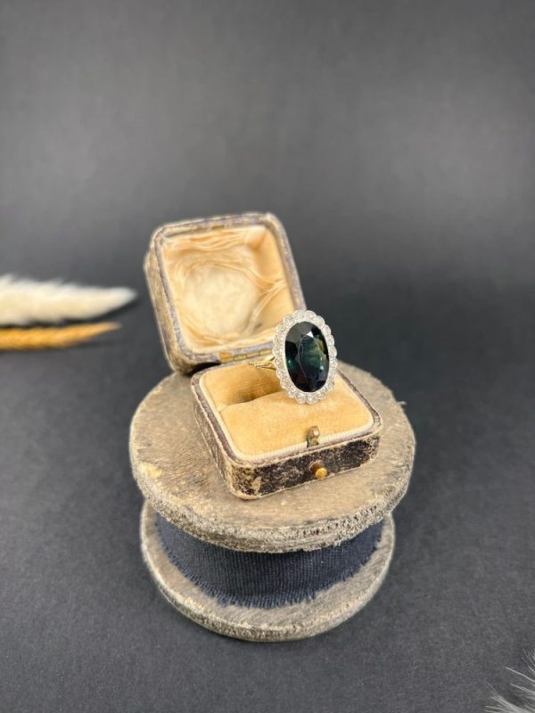 Antique sapphire and diamond cluster ring in gold and platinum.