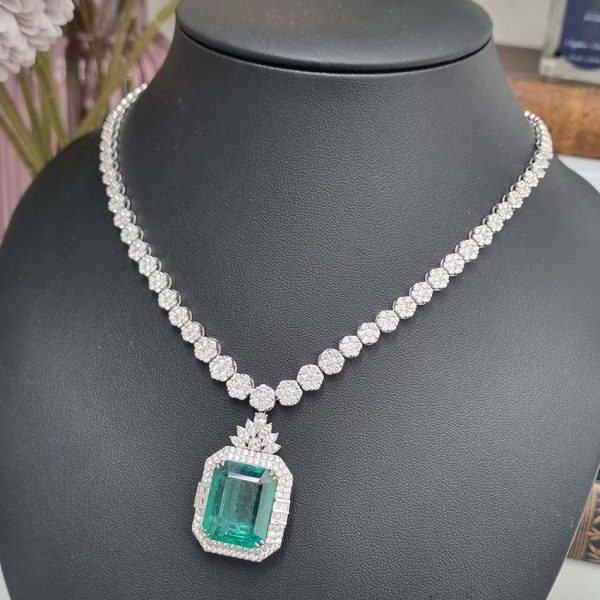 Fine 10ct Emerald and 21.50ct Diamond Cluster Pendant Necklace, emerald-cut emerald in decorative diamond surround suspended from graduated diamond floral cluster necklace