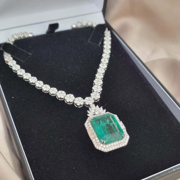 Fine 10ct Emerald and 21.50ct Diamond Cluster Pendant Necklace, emerald-cut emerald in decorative diamond surround suspended from graduated diamond floral cluster necklace