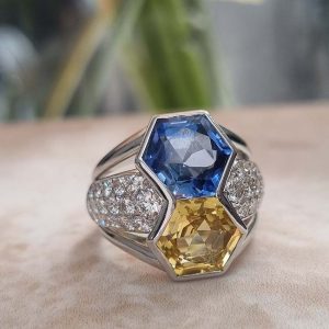 Vintage Hexagonal 8cts Yellow and Blue Sapphire Statement Ring with Diamonds, hexagonal 3.93ct yellow sapphire and 4.24ct blue sapphire set vertically flanked by 1ct pave diamonds in 18ct white gold with ribbed shoulders