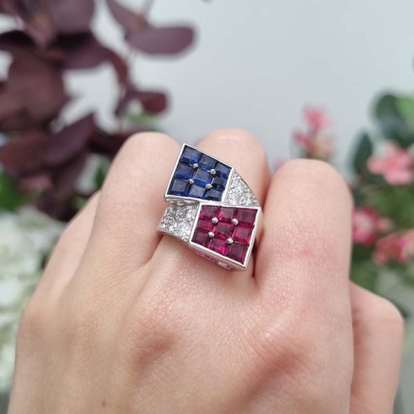 Oscar Heyman Ruby Sapphire Diamond Cocktail Statement Ring, Square cut sapphires and rubies are invisibly set into heads which lead to diamond-set crossover shoulders in 18ct white gold