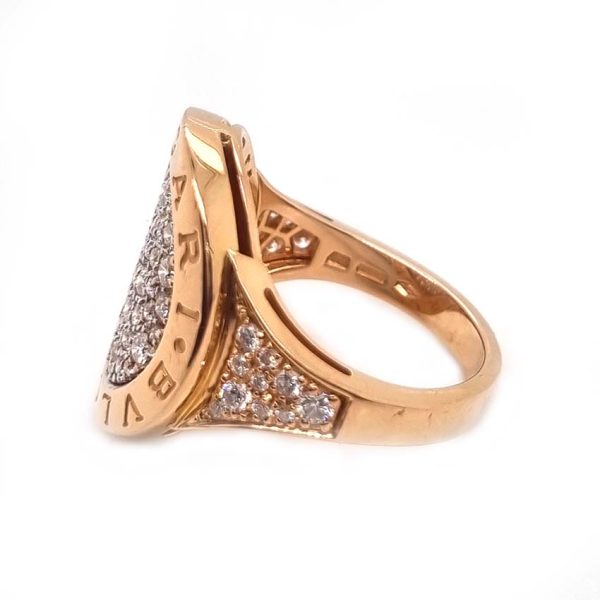 Bvlgari Pave Diamond Oval Panel Statement Ring in 18ct Rose Gold, central curved oval panel section pave-set with sparkling diamonds encased within gold border engraved with the iconic BVLGARI BVLGARI