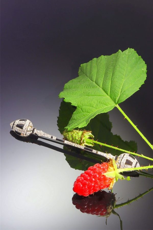 Art Deco diamond and onyx bar brooch in white gold.