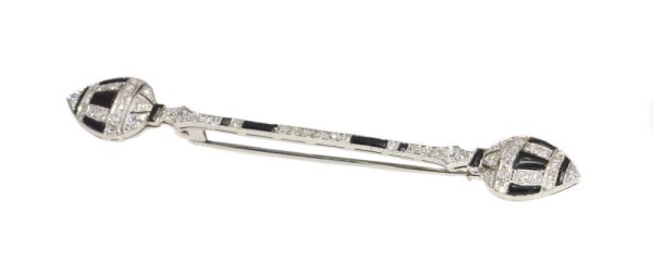 Art Deco diamond and onyx bar brooch in white gold.