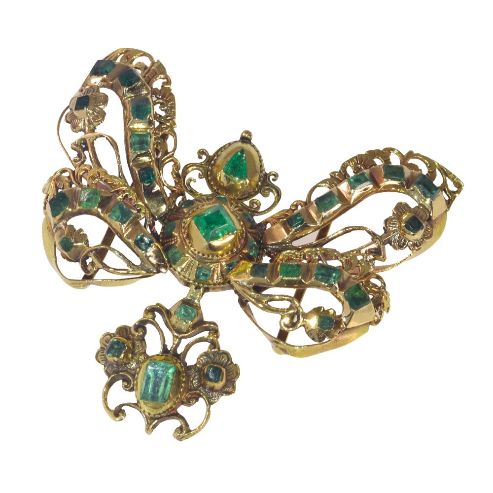 Baroque emerald bow pendant in gold.