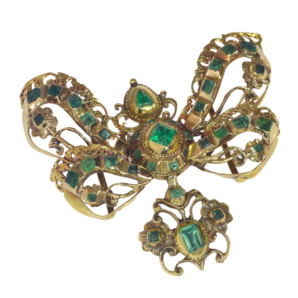 Baroque emerald bow pendant in gold.