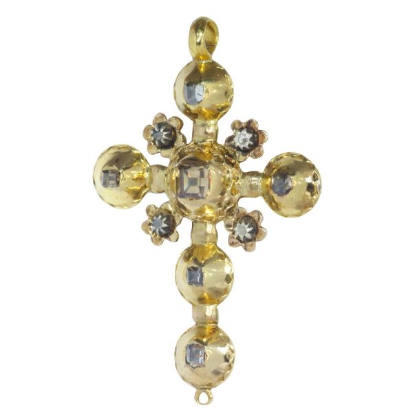 Baroque diamond cross pendant in gold.
