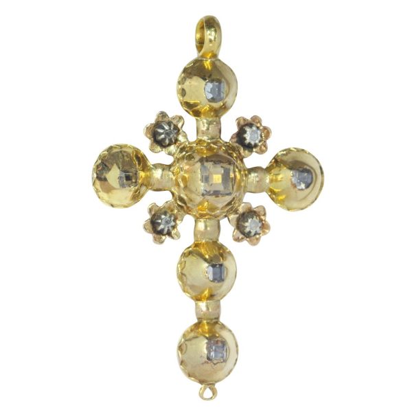 Baroque diamond cross pendant in gold.