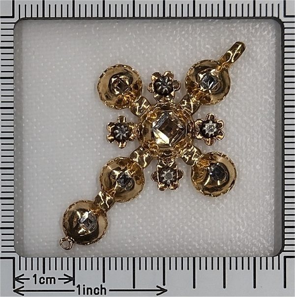 Baroque diamond cross pendant in gold.
