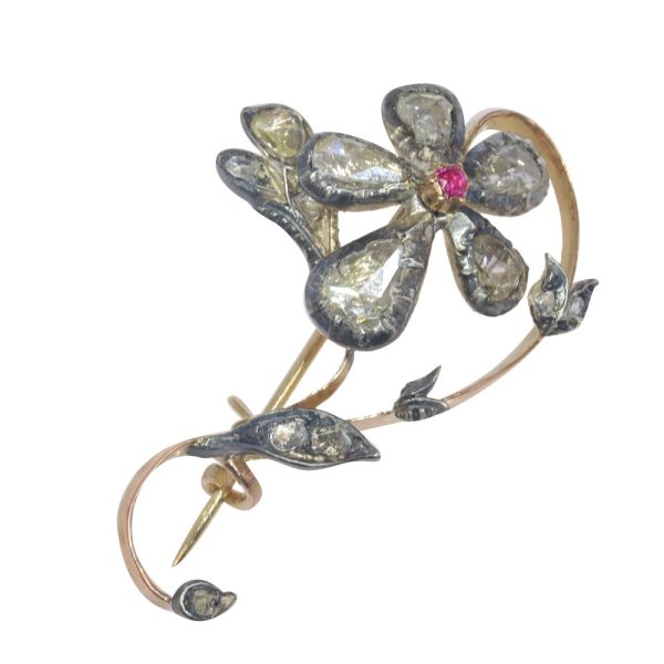 Victorian diamond and ruby brooch in gold and silver.